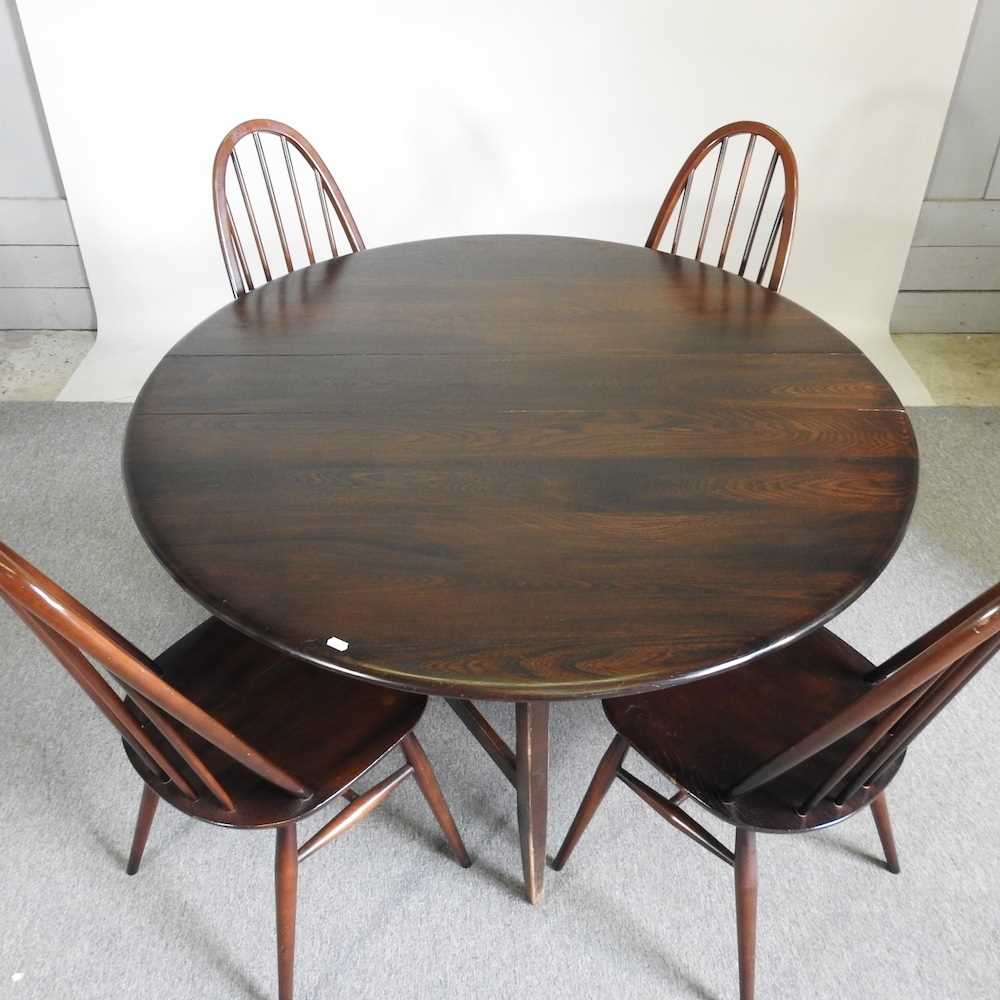 An Ercol dark elm drop leaf dining table, together with a set of four hoop back dining chairs (5) - Image 5 of 5