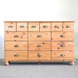 A pine merchant's chest, containing an arrangement of sixteen short drawers 132w x 40d x 82h cm