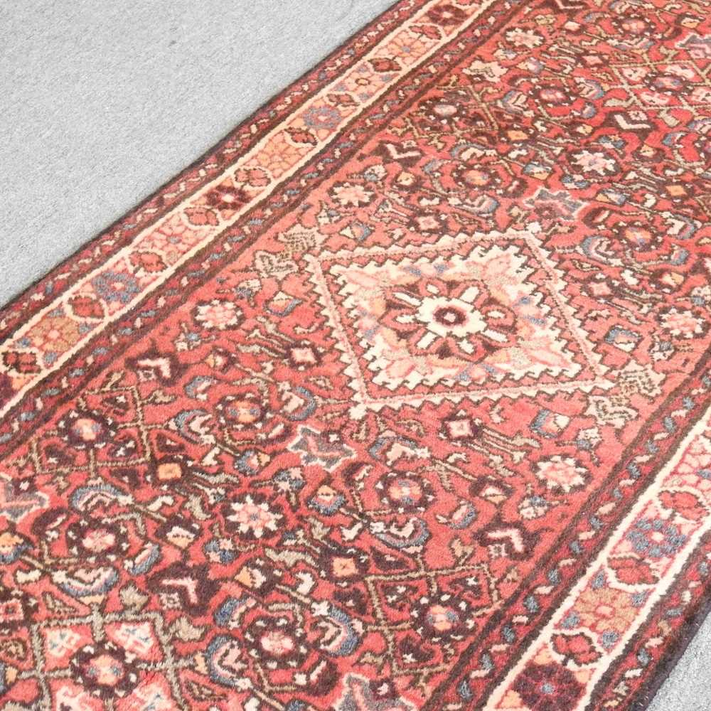 A Persian malayer runner, with flowerhead motifs, on a red ground, 308 x 85cm - Image 4 of 5