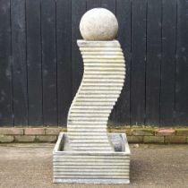 A composition garden fountain, on curved design, surmounted by a ball 60w x 60d x 136h cm Overall