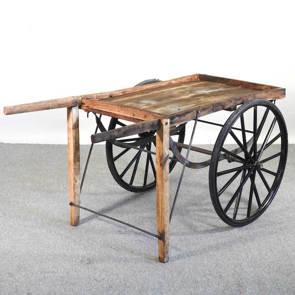 A wooden hand cart, with spoked wheels 146w x 80d x 72h cm