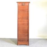 An early 20th century oak tambour front filling cabinet, on a plinth base 46w x 39d x 151h cm