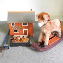 A painted doll's house and contents, together with a children's rocking horse and a pogo stick