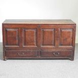 An 18th century oak mule chest, with a panelled front and drawers below 133w x 51d x 72h cm