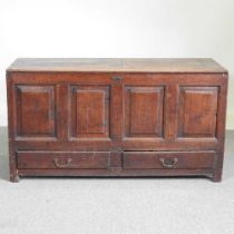 An 18th century oak mule chest, with a panelled front and drawers below 133w x 51d x 72h cm