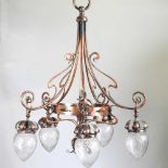 An Art Nouveau bronzed five branch chandelier, with whiplash supports and cut glass shades, 70cm