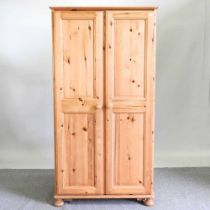 A modern pine double wardrobe, on turned feet 96w x 59d x 184h cm