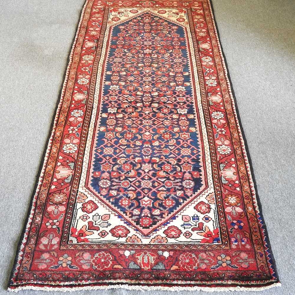 A Malayer runner, with all over flowerhead designs, 300 x 115cm