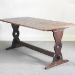 An early 20th century oak refectory table, with a plank top, on a trestle base 166w x 84d x 76h cm