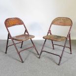 A painted metal folding chair, together with another (2)