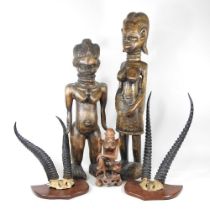 An African carved figure, 74cm high, together with two others and two pairs of mounted taxidermy