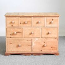 A pine narrow chest of drawers, containing an arrangement of nine short drawers 90w x 33d x 68h cm