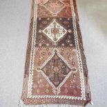 A Persian kelim runner, with a row of three central diamonds, 336 x 132cm