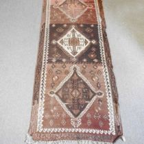 A Persian kelim runner, with a row of three central diamonds, 336 x 132cm