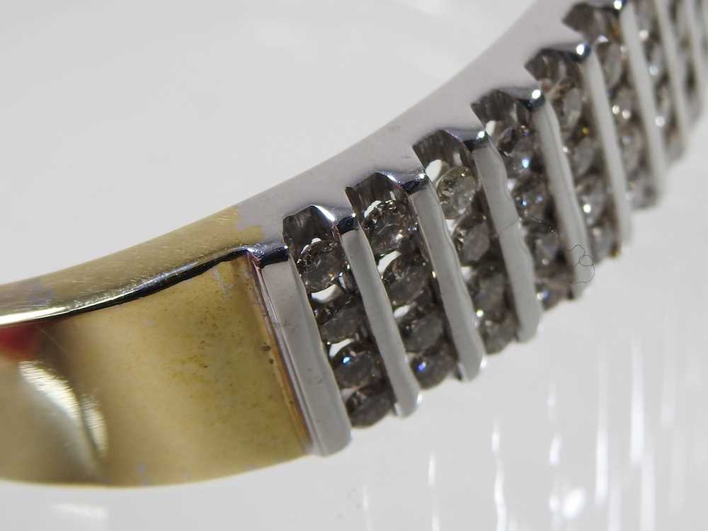A 14 carat gold and diamond bangle, of hinged design, set with seventeen rows of four diamonds, - Image 6 of 6