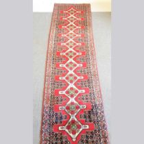 A Persian senneh runner, with a central row of diamonds, 385 x 94cm