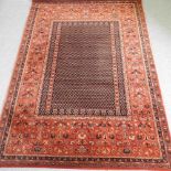 A modern woollen rug, with a foliate designs on a red ground, 296 x 103 cm