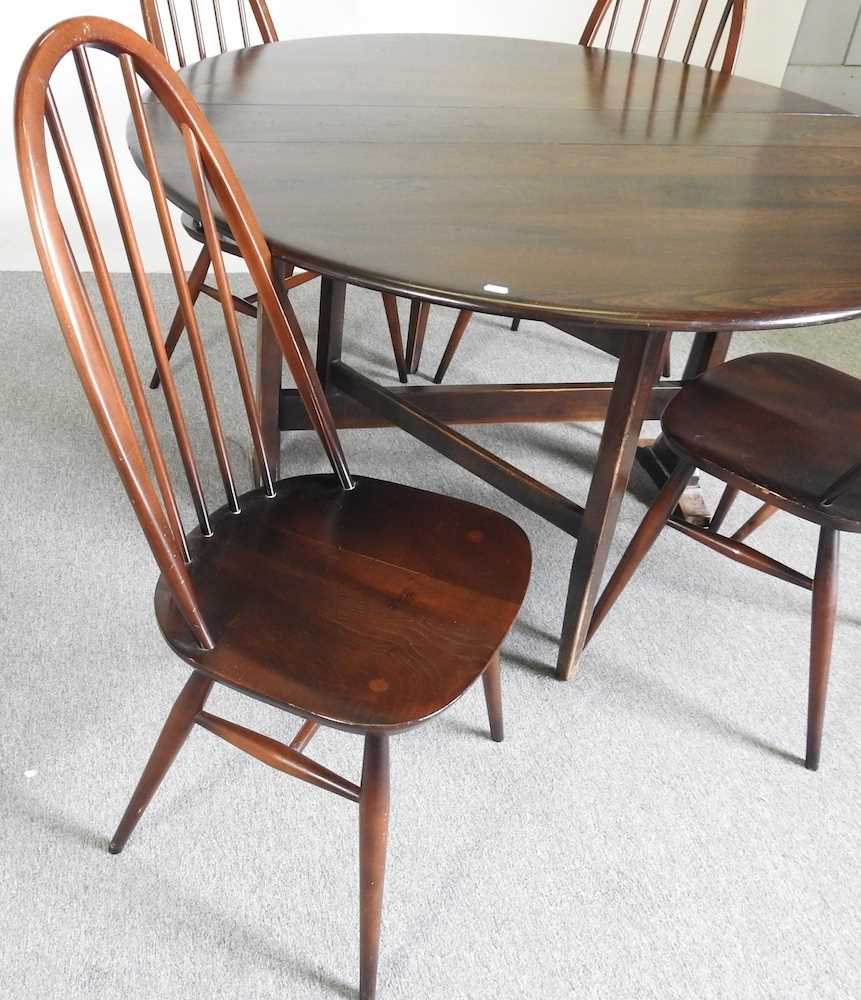 An Ercol dark elm drop leaf dining table, together with a set of four hoop back dining chairs (5) - Image 4 of 5