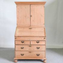 A 19th century stripped pine bureau cabinet, with a fitted interior 96w x 55d x 179h cm