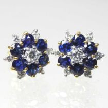 A pair of 18 carat gold, diamond and sapphire cluster earrings, of flowerhead design, each set