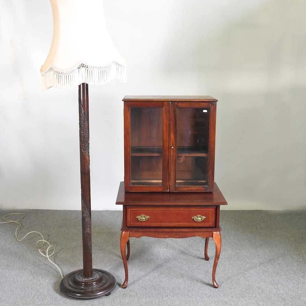 An early 20th century glazed cabinet on stand, together with a standard lamp and shade (2) 72w x 51d