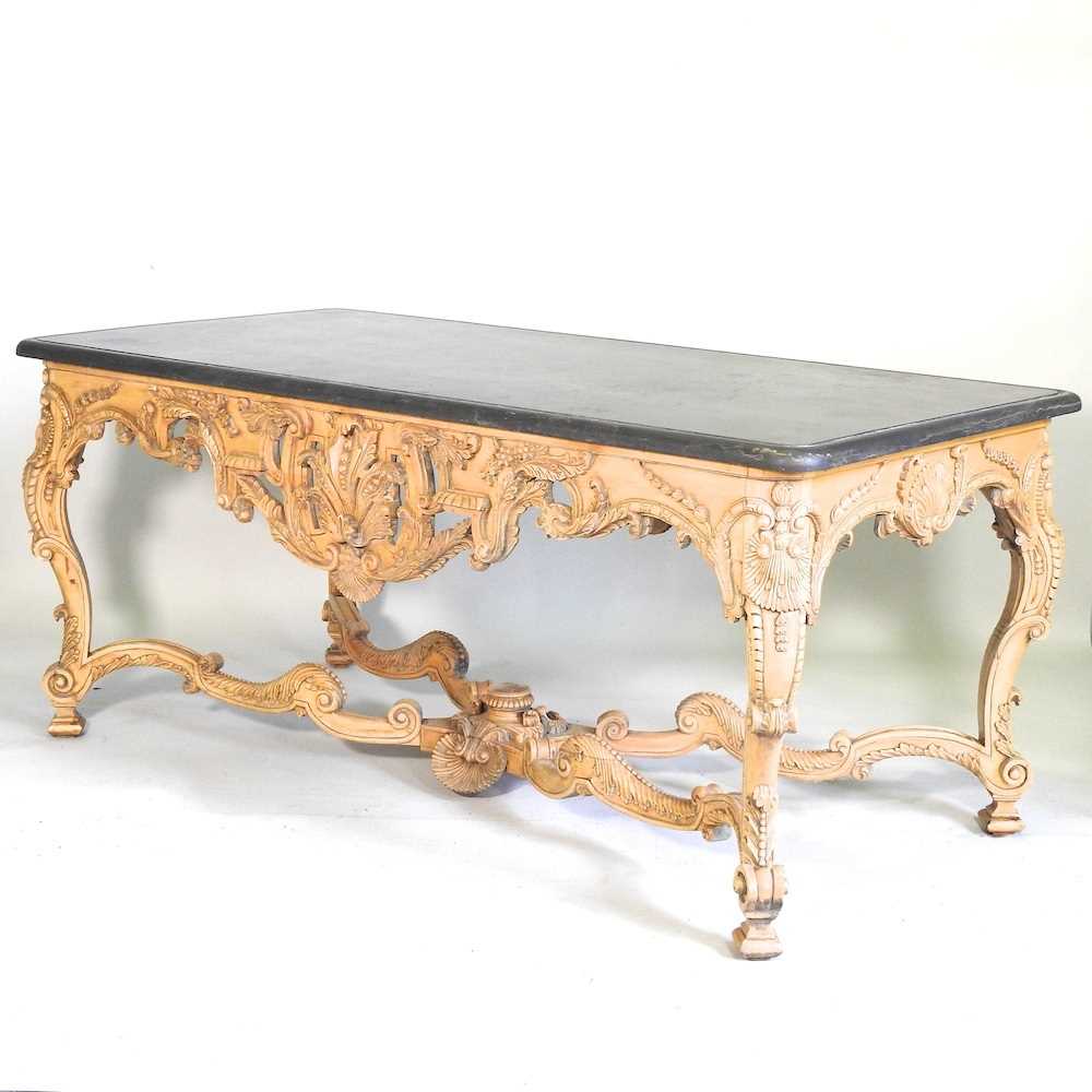 A large continental carved wood centre table, 20th century, the rectangular marble top, on an ornate