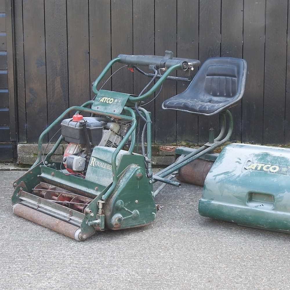 An Atco Royale B24E cylinder ride on petrol lawn mower Overall condition looks to be complete, but
