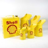 A reproduction Shell metal advertising petrol can, 31cm high, together with a set of five