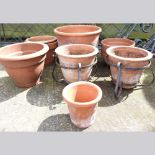 A terracotta garden pot, together with six others (7)