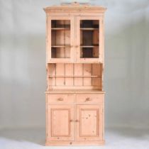 A pine side cabinet, with a glazed upper section, drawers and cupboards below 98w x 44d x 233h cm