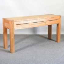 A modern light oak console table, containing three drawers 150w x 45d x 75h cm
