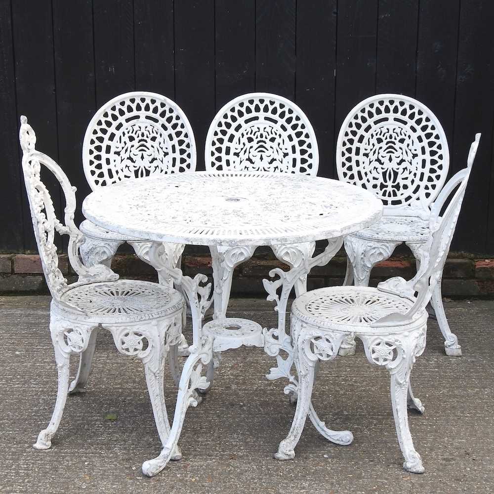 A white painted metal circular garden table, together with a pair of chairs and three others similar