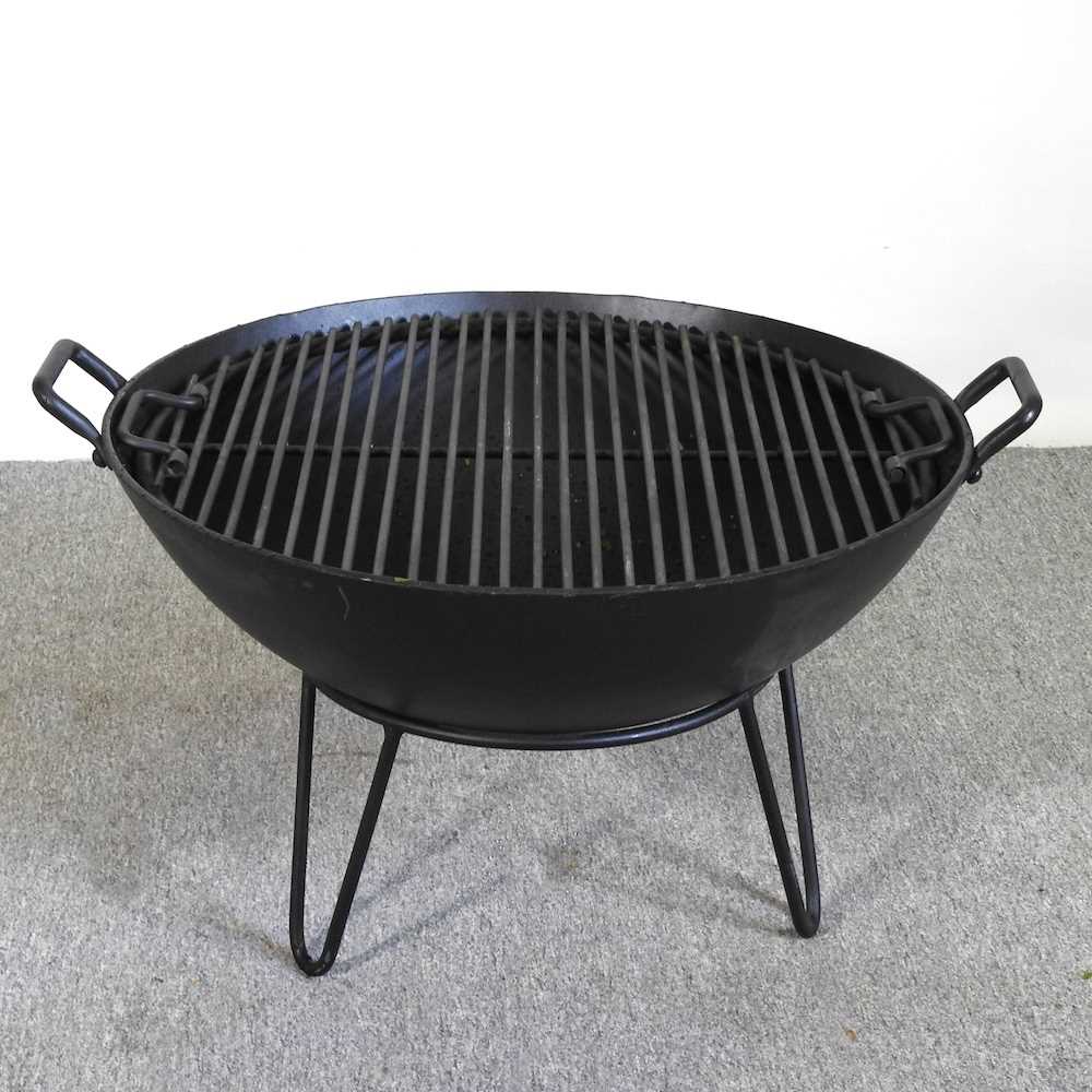 A black metal fire pit, with grille, 68cm wide