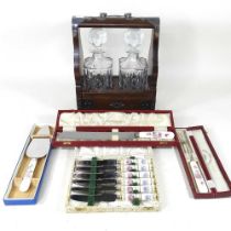 An early 20th century tantalus, together with a collection of cutlery, some boxed