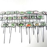 A set of six painted metal salad markers, six vegetable and ten herb markers