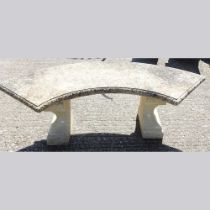 A cast stone garden bench, of curved shape 130w x 60d x 40h cm
