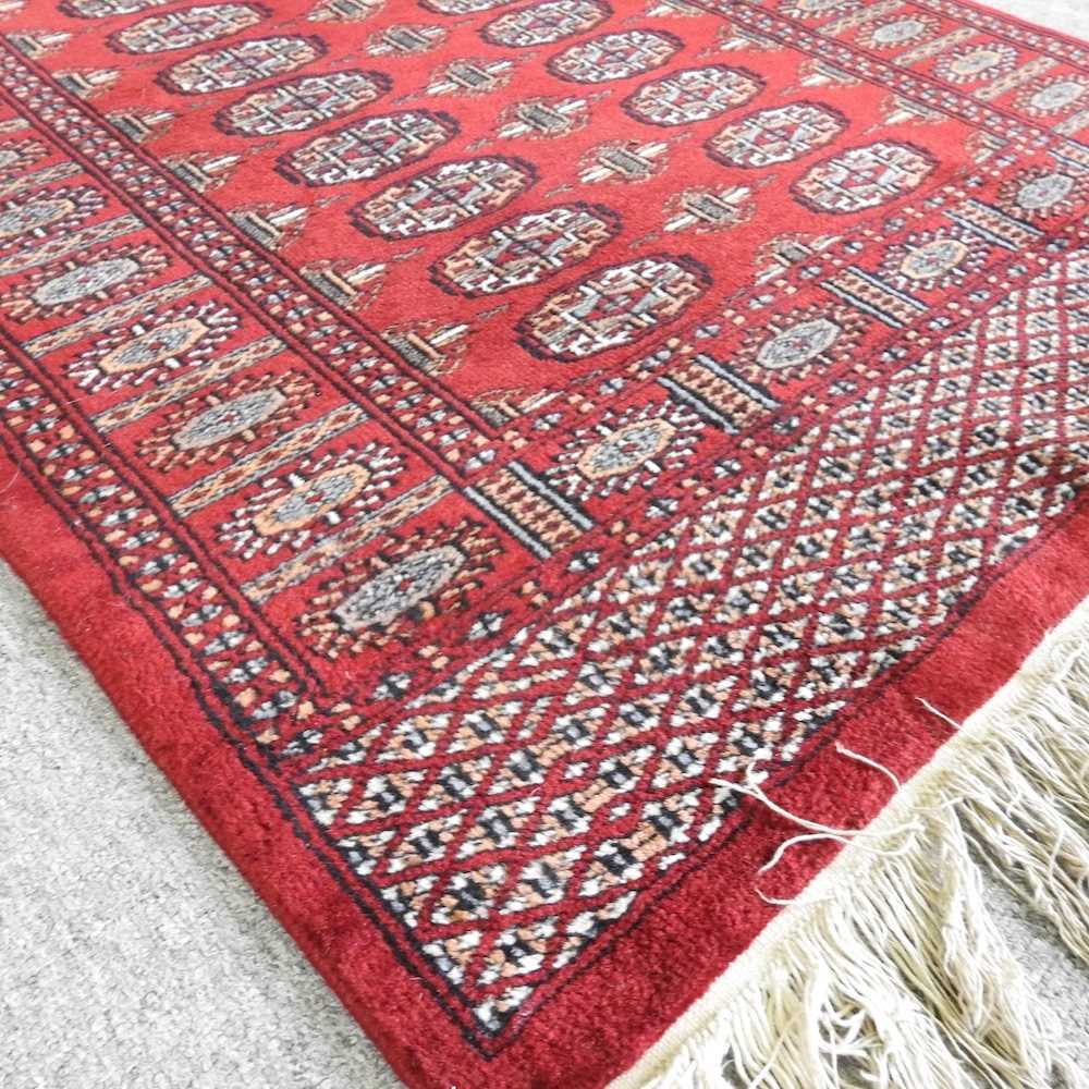 A Bokhara woollen rug, with two rows of medallions, on a red ground, 160 x 92cm - Image 3 of 3