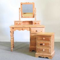 A pine dressing table, together with a pine mirror and a bedside chest (3) 106w x 45d x 149h cm