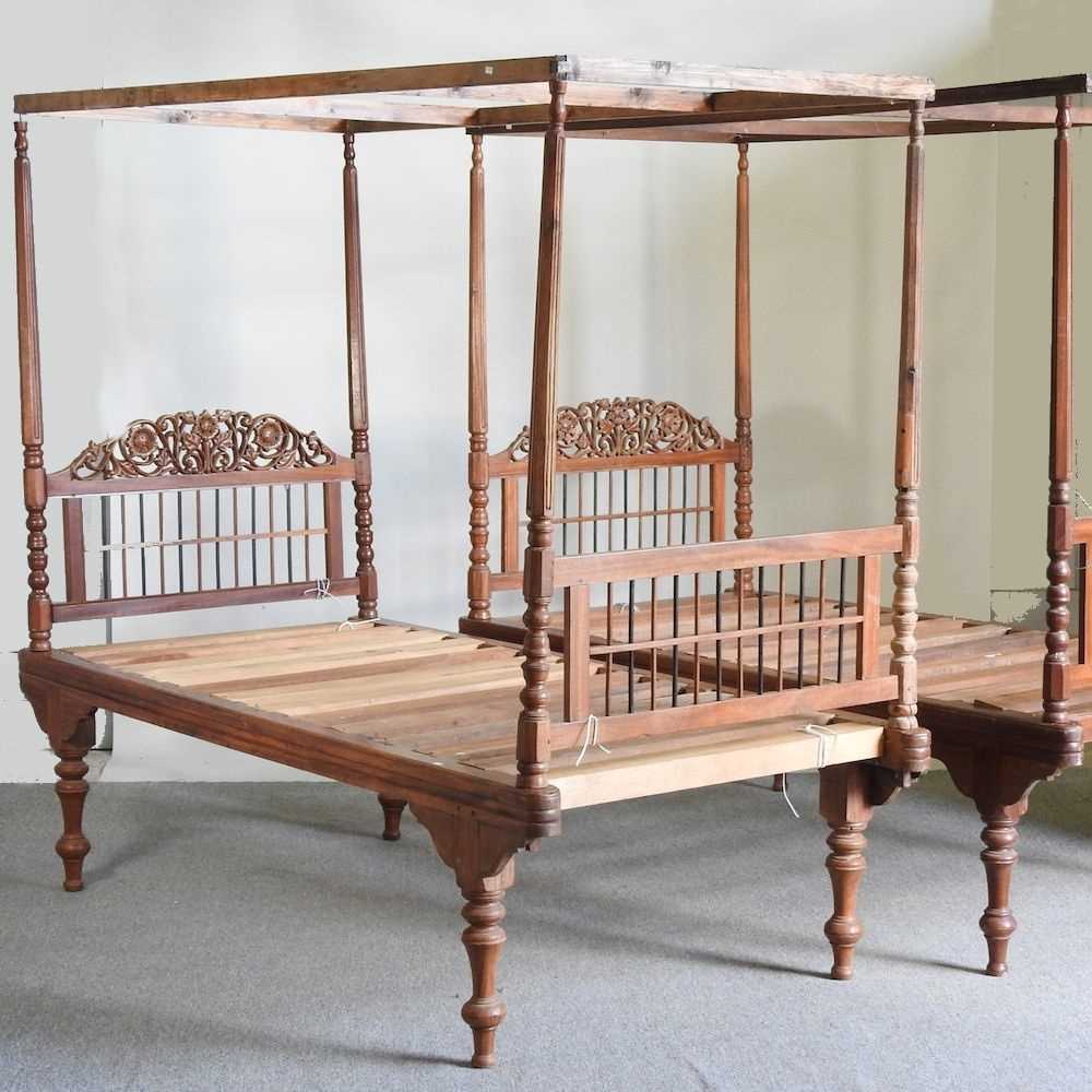 A near pair of Indonesian teak four poster canopy beds, on turned legs (2) 203w x 100d x 188h cm