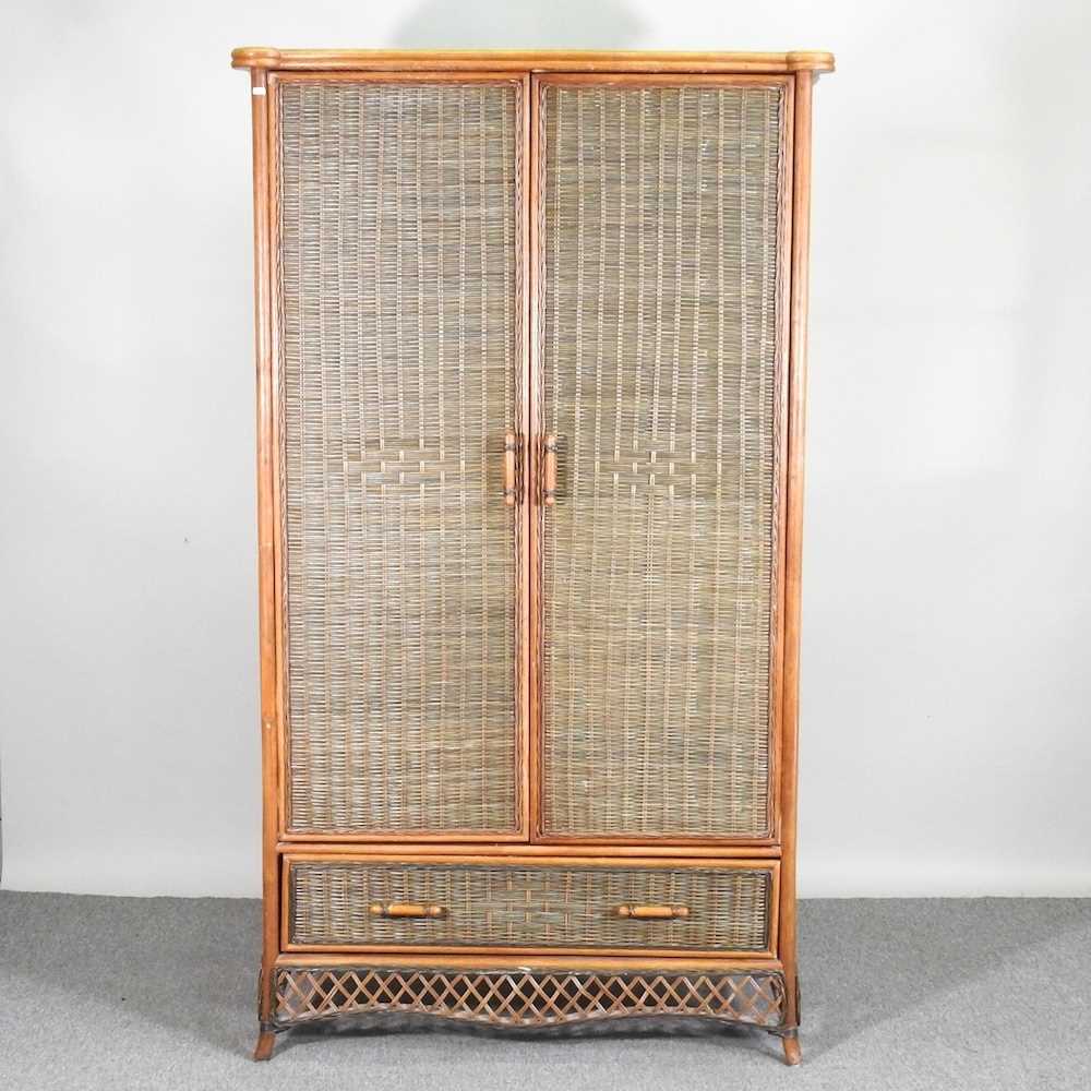 A wicker double wardrobe, with a drawer below 108w x 59d x 193h cm