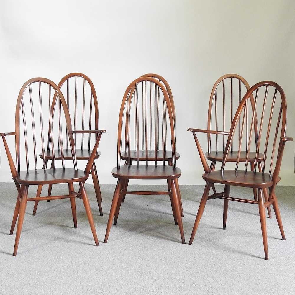 A set of six Ercol dark elm hoop back dining chairs, to include a pair of carvers (6)