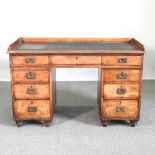 A 19th century campaign style pedestal desk, with a removable gallery back and inset writing surface