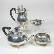 An Edwardian Art Nouveau silver three piece tea service, comprising teapot, 24cm long, sugar bowl