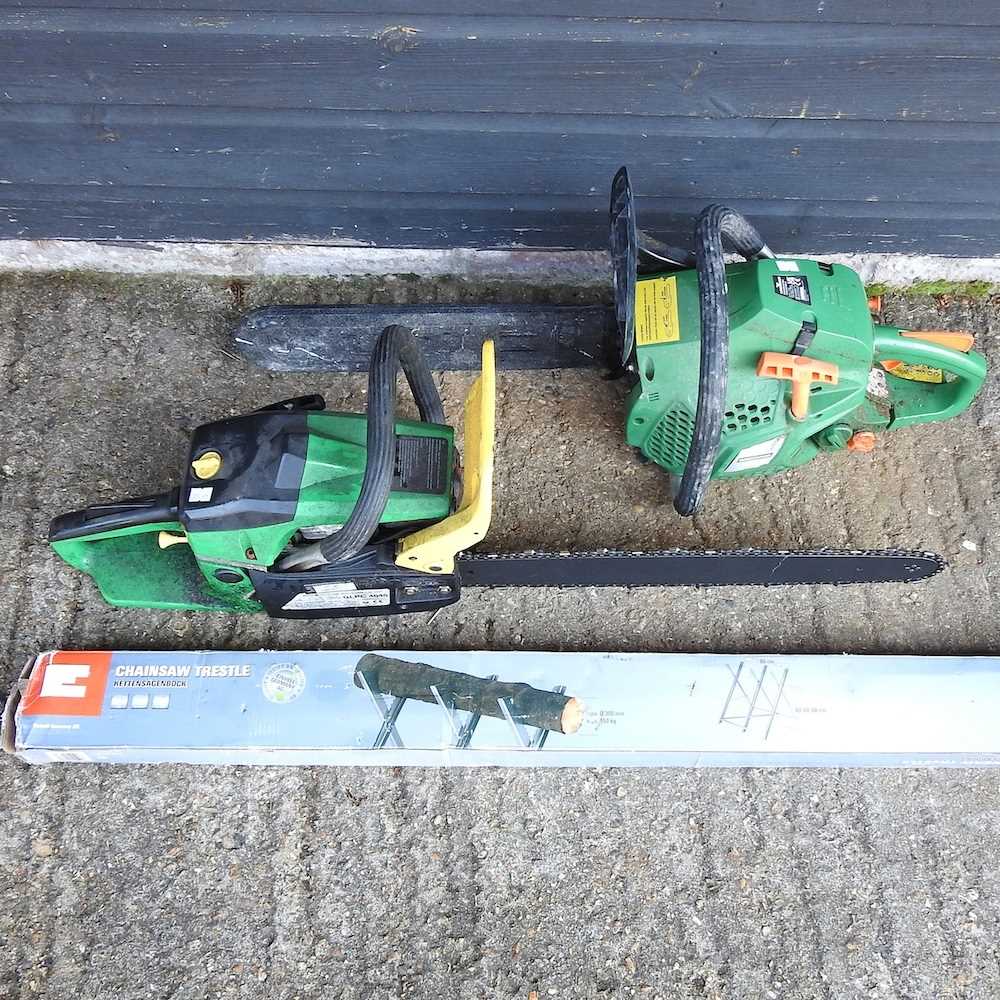 A petrol chainsaw, together with another and a chainsaw trestle (3)