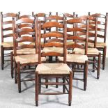 A set of ten oak ladderback dining chairs, 20th century, with rush seats, on turned legs (10)
