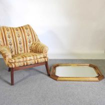 A 1970's upholstered armchair, together with a gilt framed wall mirror, 65 x 86cm (2)