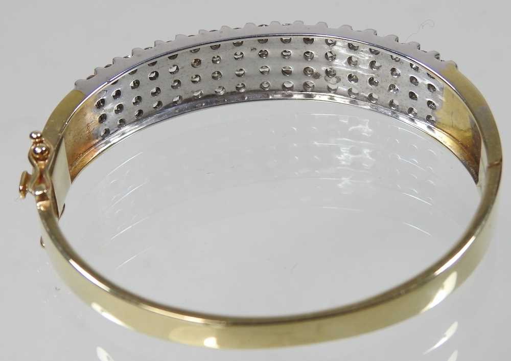 A 14 carat gold and diamond bangle, of hinged design, set with seventeen rows of four diamonds, - Image 4 of 6