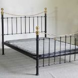 A Victorian style brass and iron double bedstead, with a sprung base 155w x 212l cm