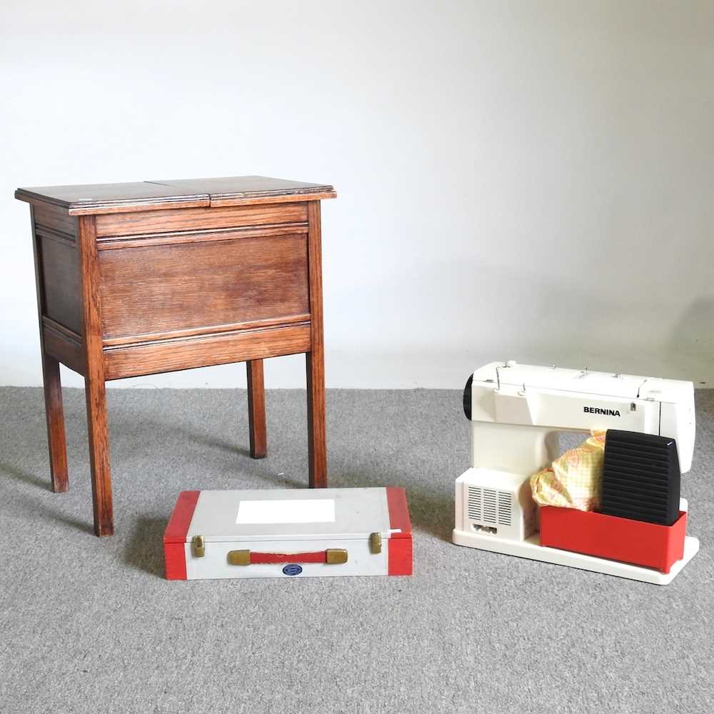 A Bernina sewing machine, cased, together with a 1930's sewing table and contents (2) Sewing machine