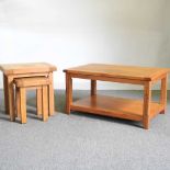 A modern light oak coffee table, 92cm wide, together with a nest of two matching occasional